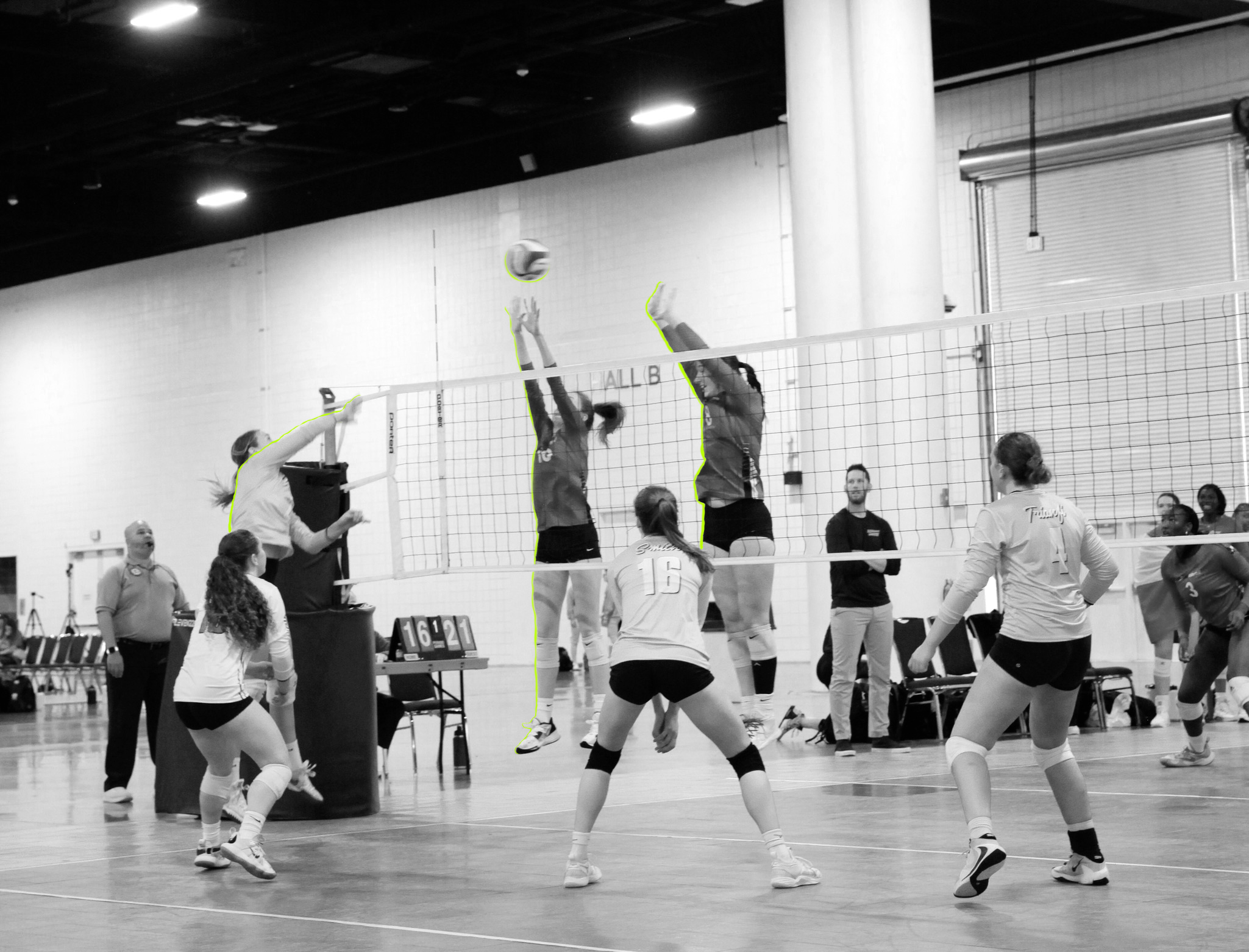 girls jumping to hit volleyball