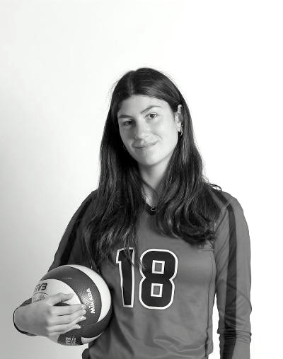 Portrait of Emily, a volleyball player holding a volleyball